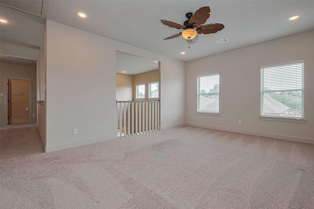 spare room featuring recessed lighting, ceiling fan, visible vents, and light carpet