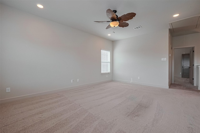 spare room with attic access, visible vents, light colored carpet, and recessed lighting