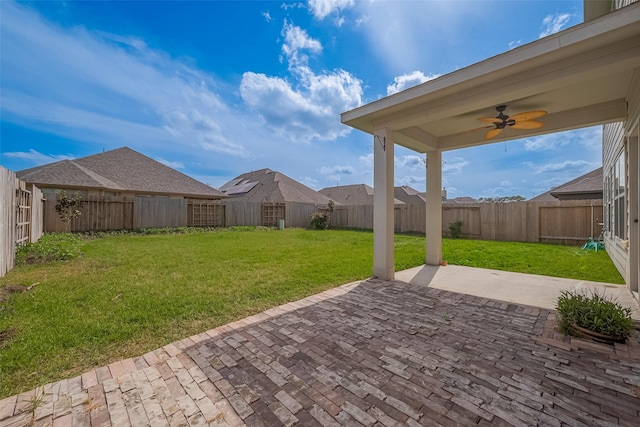 view of yard featuring a fenced backyard, a patio area, and ceiling fan