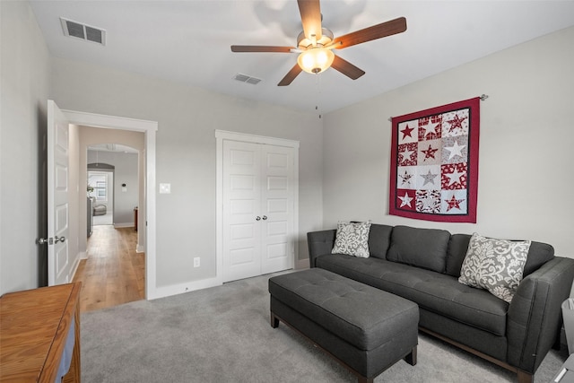 18611 Admiration Dr, Cypress, TX 77433 - living area featuring light carpet, visible vents, arched walkways, and ceiling fan