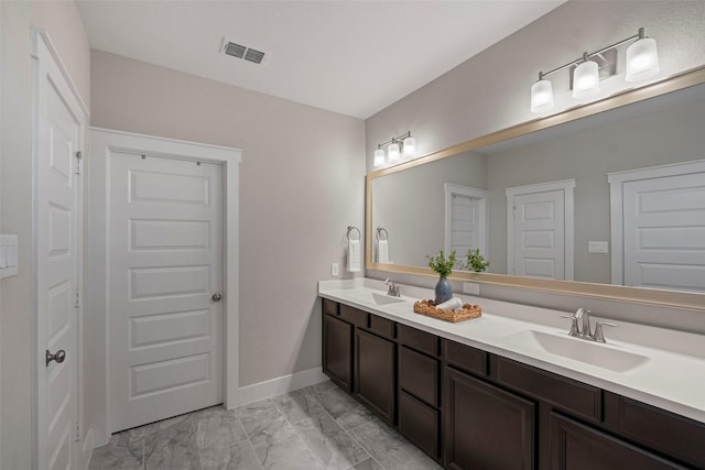 18611 Admiration Dr, Cypress, TX 77433 - bathroom with visible vents, a sink, marble finish floor, and double vanity