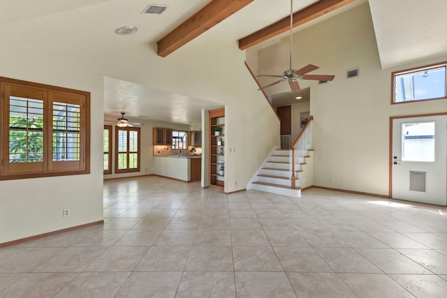 unfurnished living room featuring light tile patterned floors, baseboards, visible vents, and ceiling fan