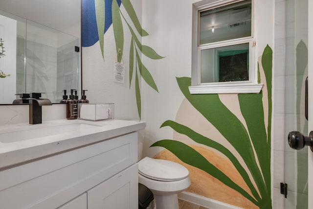 full bath featuring toilet, vanity, and a stall shower