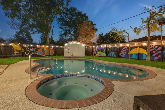 view of pool featuring a storage unit, a pool with connected hot tub, an outbuilding, and a fenced backyard