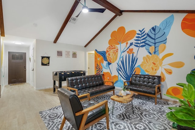 living room featuring lofted ceiling with beams, baseboards, light wood finished floors, and visible vents