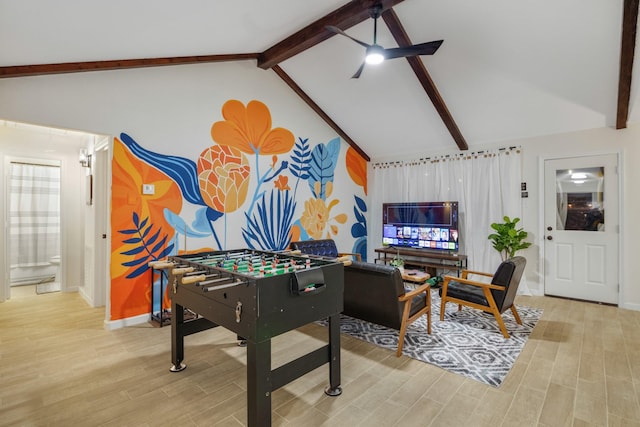 recreation room with ceiling fan, light wood finished floors, baseboards, and lofted ceiling with beams