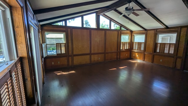 unfurnished sunroom featuring beamed ceiling