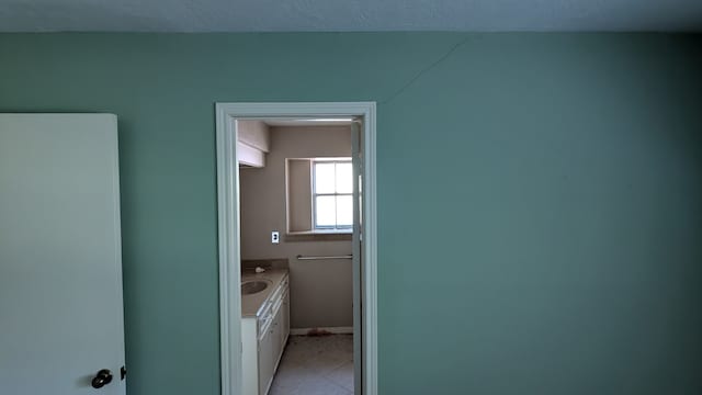 bathroom with tile patterned floors, baseboards, and vanity