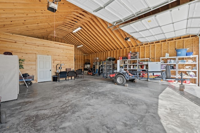 garage with wooden walls and a garage door opener