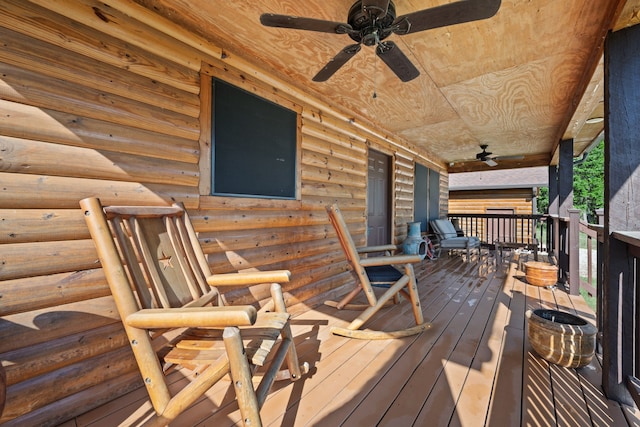 wooden deck with a porch and ceiling fan