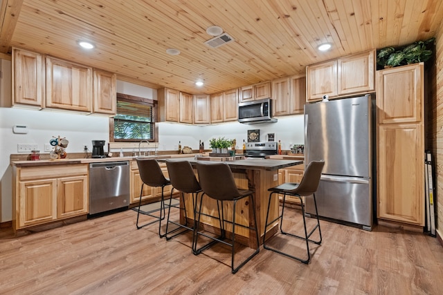kitchen featuring light brown cabinets, visible vents, light wood-style floors, and appliances with stainless steel finishes