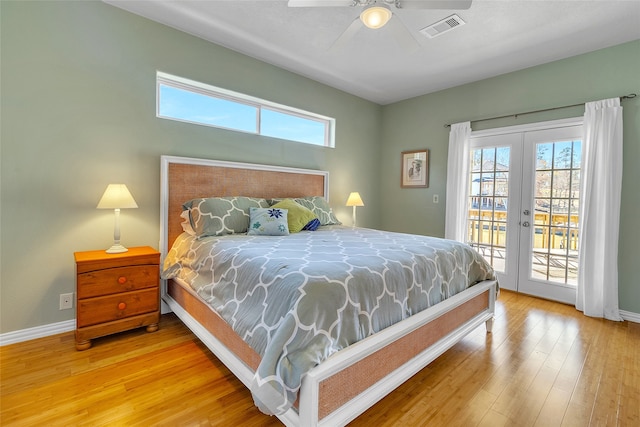 bedroom featuring wood finished floors, visible vents, access to exterior, and multiple windows