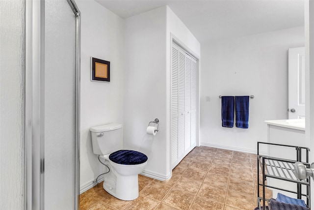 full bath with baseboards and toilet
