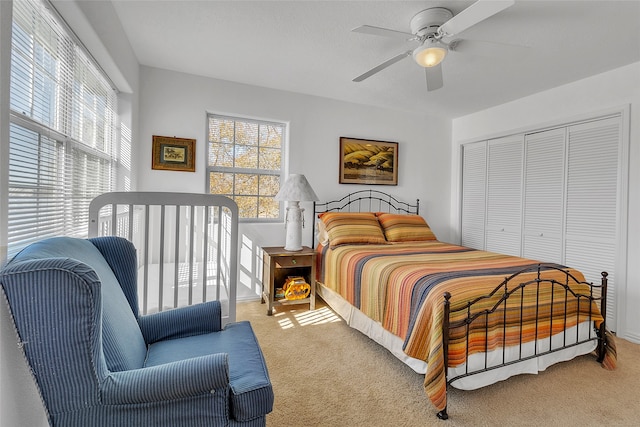 bedroom with carpet floors, a ceiling fan, and a closet