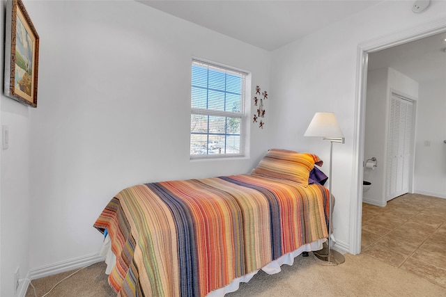 carpeted bedroom featuring baseboards