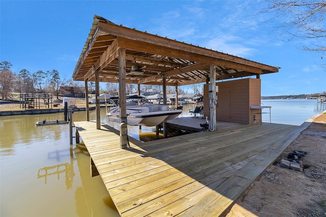 view of dock with boat lift and a water view
