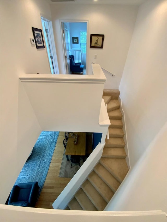 stairs featuring wood finished floors