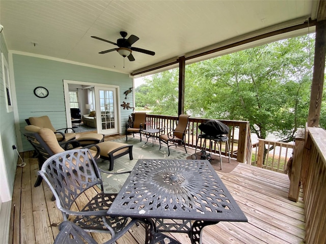 deck with outdoor dining space and ceiling fan