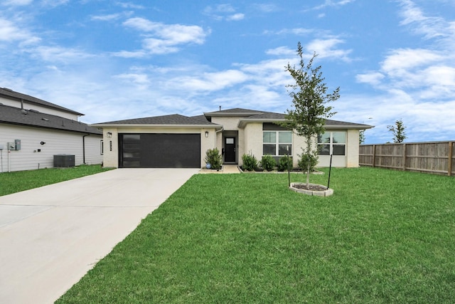 prairie-style house with central AC, fence, a front yard, an attached garage, and driveway