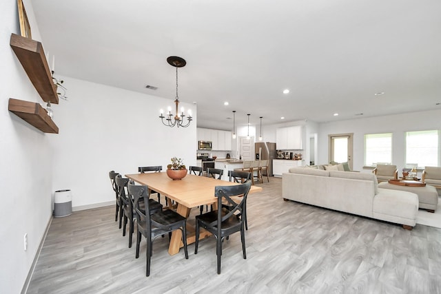 dining space featuring visible vents, baseboards, a chandelier, recessed lighting, and light wood-style flooring