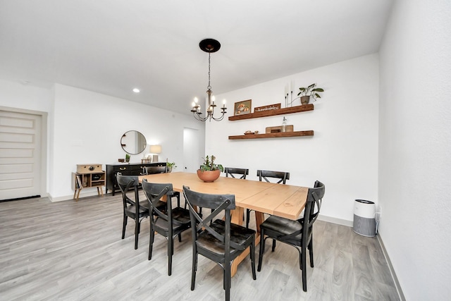dining area featuring light wood-style floors, recessed lighting, baseboards, and a chandelier