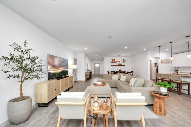 living room with recessed lighting and light wood finished floors