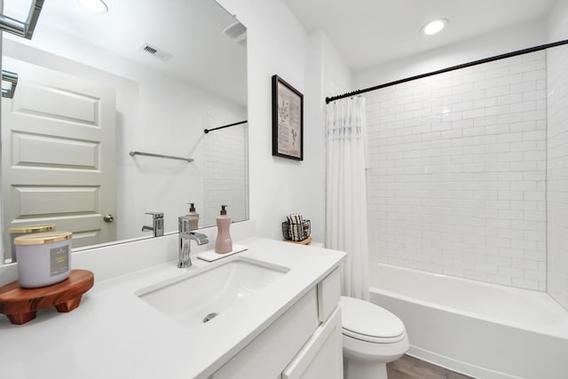 bathroom featuring vanity, toilet, shower / bathtub combination with curtain, recessed lighting, and visible vents