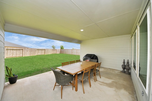 view of patio with outdoor dining space and a fenced backyard