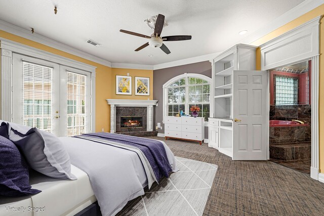 1002 Island Vw, League City, TX 77565 - bedroom featuring a glass covered fireplace, ornamental molding, dark colored carpet, access to exterior, and visible vents