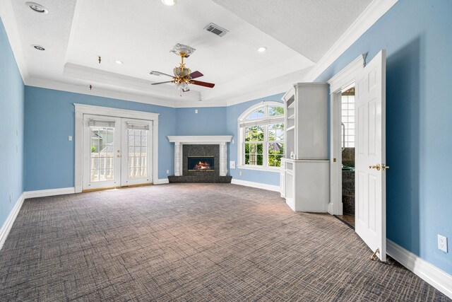 1002 Island Vw, League City, TX 77565 - unfurnished living room featuring visible vents, a ceiling fan, a tray ceiling, and carpet