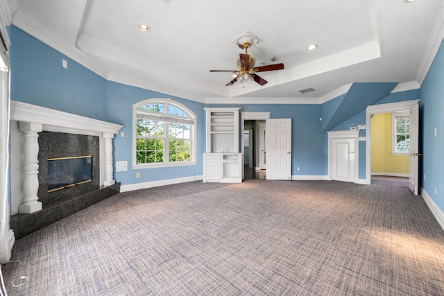 1002 Island Vw, League City, TX 77565 - unfurnished living room with a high end fireplace, a raised ceiling, carpet flooring, and a ceiling fan