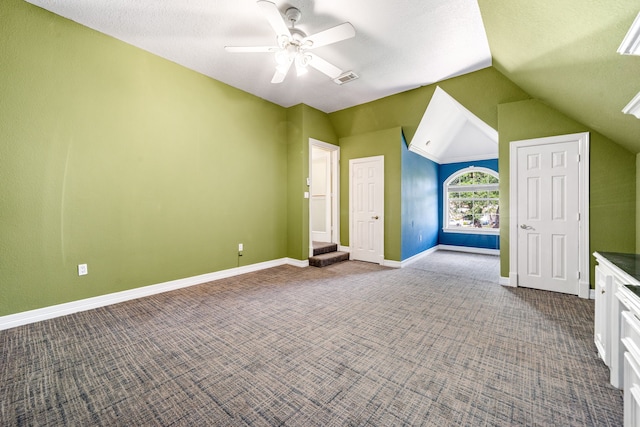 1002 Island Vw, League City, TX 77565 - interior space with vaulted ceiling, baseboards, visible vents, dark carpet, and ceiling fan