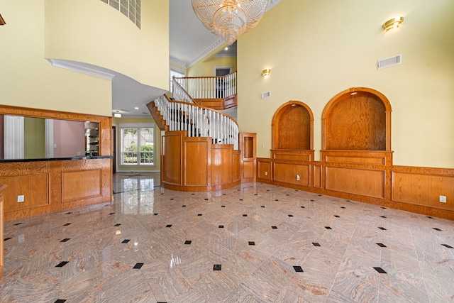 1002 Island Vw, League City, TX 77565 - foyer with stairway, a high ceiling, wainscoting, and visible vents