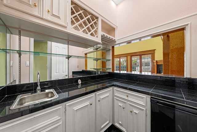 1002 Island Vw, League City, TX 77565 - kitchen with white cabinets, dishwasher, tile countertops, and a sink