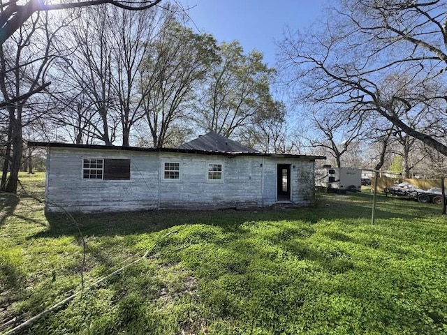 rear view of property featuring a yard