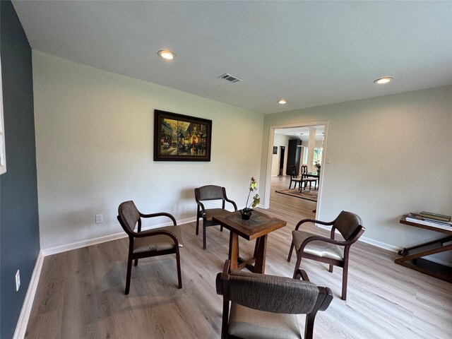 sitting room featuring baseboards, visible vents, wood finished floors, and recessed lighting