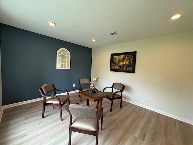 sitting room with baseboards, visible vents, light wood-style flooring, and recessed lighting