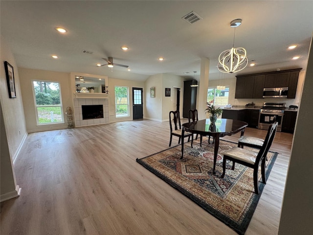 dining area featuring light wood finished floors, visible vents, a wealth of natural light, and baseboards