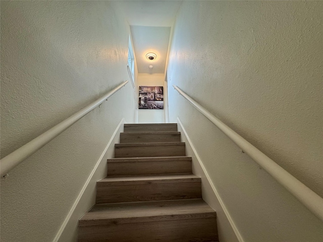 stairway with a textured wall