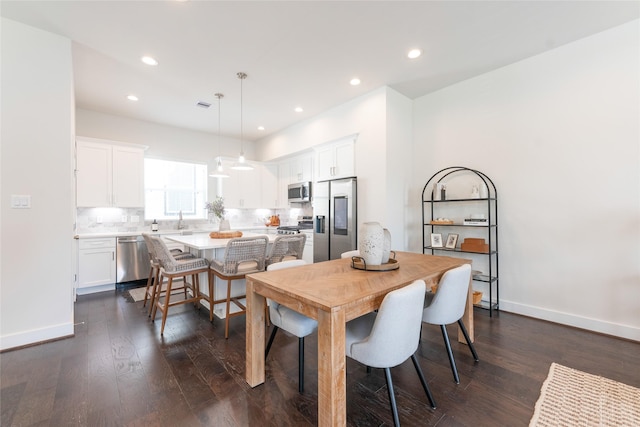 dining space featuring baseboards, recessed lighting, and dark wood-type flooring