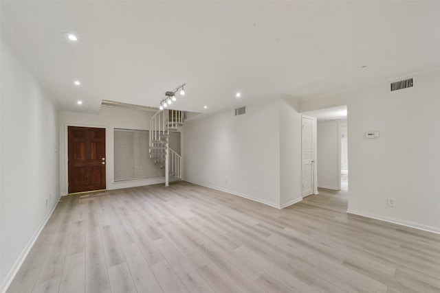 2507 Montrose Blvd Unit 50, Houston, TX 77006 - unfurnished living room featuring visible vents, light wood finished floors, and stairs