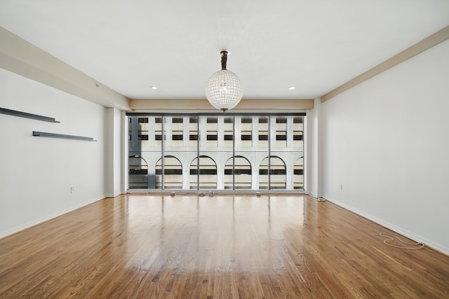 unfurnished living room featuring baseboards, wood finished floors, and recessed lighting