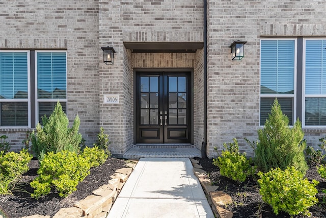 doorway to property with brick siding and french doors