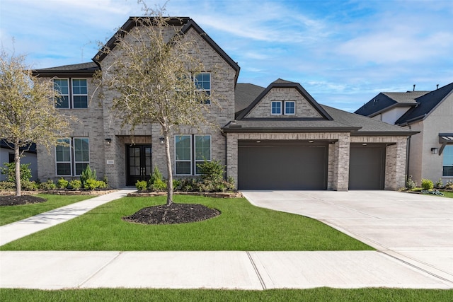view of front facade featuring brick siding, an attached garage, a front lawn, and concrete driveway