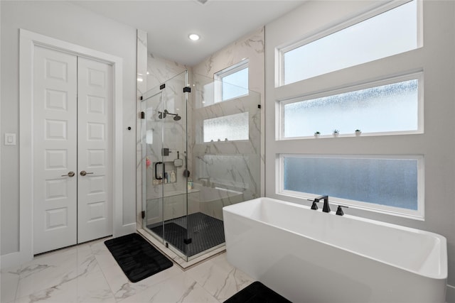 full bathroom with marble finish floor, a soaking tub, a marble finish shower, and recessed lighting