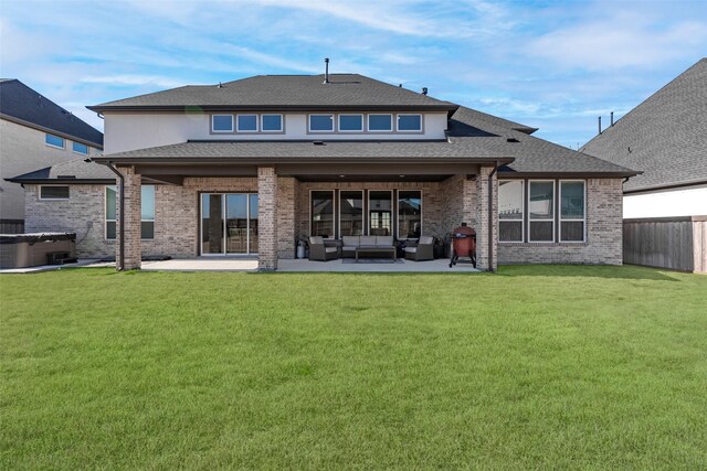 rear view of property with fence private yard, a patio, an outdoor living space, brick siding, and a hot tub