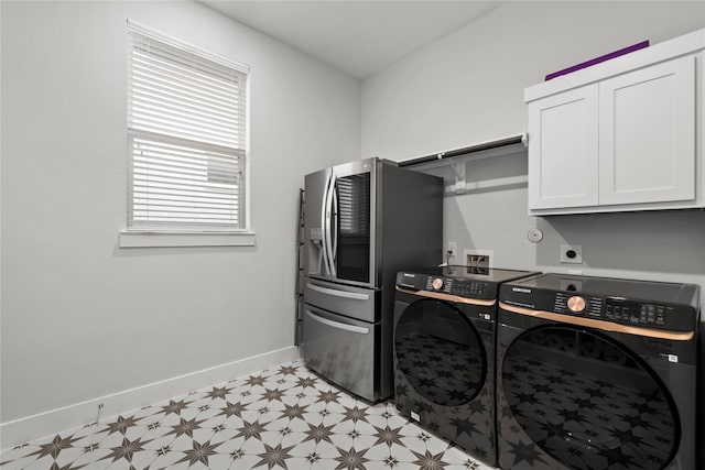 laundry room with light floors, baseboards, cabinet space, and independent washer and dryer