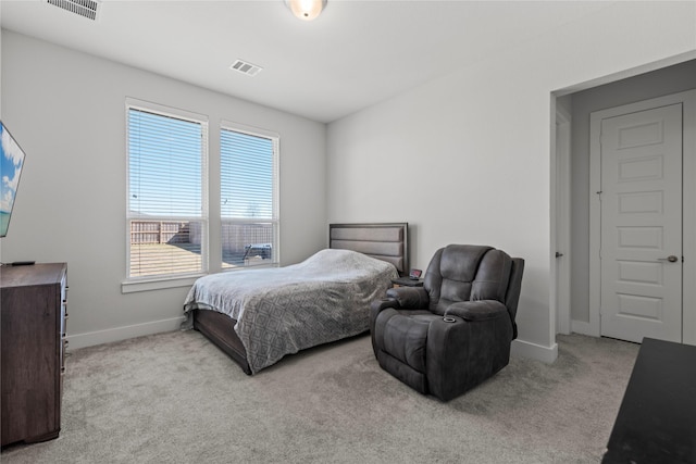 carpeted bedroom with visible vents and baseboards