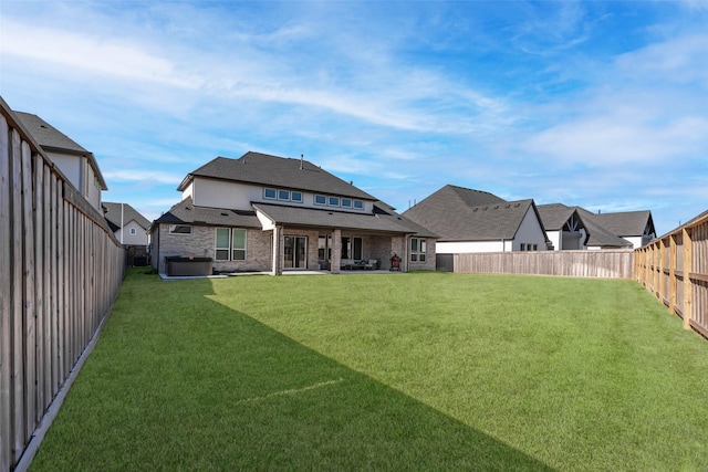 back of house with a shingled roof, a fenced backyard, a patio, a lawn, and brick siding