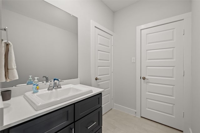 bathroom with baseboards and vanity